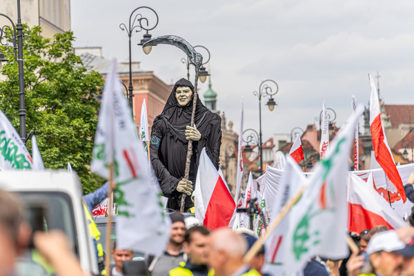 A grim reaper is seen amidst a crowd of protesters with Polish and "Solidarity" flags during the demonstration. Polish trade unions, farmers and opponents of Poland's pro-European Union government gathered in downtown Warsaw to protest against the European Union's Green Deal and climate policies. The march was organized by the Independent Self-Governing Trade Union "Solidarity" (NSZZ "Solidarnosc") representing the interests of farmers, who strongly oppose the EU's climate policies, by the national conservative opposition Law and Justice party.