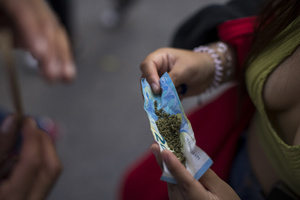A protester holds marijuana on a 20 euro bill, during a demonstration in the streets of Madrid, commemorating the World Marijuana March. Since 1999, every first Saturday in May the World Marijuana day is celebrated worldwide. Those who participated in the march demanded that marijuana should be legalized and ask that cultivation and possession not be criminalized.