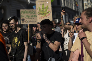 A protester smokes a large joint, during a demonstration through the streets of Madrid, commemorating the World Marijuana March. Since 1999, every first Saturday in May the World Marijuana day is celebrated worldwide. Those who participated in the march demanded that marijuana should be legalized and ask that cultivation and possession not be criminalized.