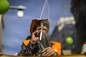 A protester holds a large joint, during a demonstration through the streets of Madrid, commemorating the World Marijuana March. Since 1999, every first Saturday in May the World Marijuana day is celebrated worldwide. Those who participated in the march demanded that marijuana should be legalized and ask that cultivation and possession not be criminalized.