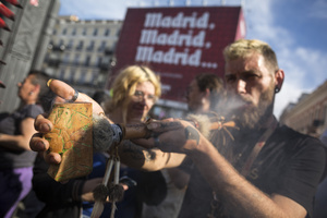 A protester smokes a large pipe, during a demonstration through the streets of Madrid, commemorating the World Marijuana March. Since 1999, every first Saturday in May the World Marijuana day is celebrated worldwide. Those who participated in the march demanded that marijuana should be legalized and ask that cultivation and possession not be criminalized.