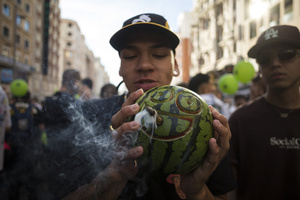 A protester smokes from a watermelon, during a demonstration through the streets of Madrid, commemorating the World Marijuana March. Since 1999, every first Saturday in May the World Marijuana day is celebrated worldwide. Those who participated in the march demanded that marijuana should be legalized and ask that cultivation and possession not be criminalized.