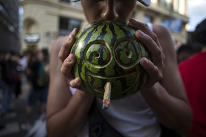 A protester smokes from a watermelon, during a demonstration through the streets of Madrid, commemorating the World Marijuana March. Since 1999, every first Saturday in May the World Marijuana day is celebrated worldwide. Those who participated in the march demanded that marijuana should be legalized and ask that cultivation and possession not be criminalized.