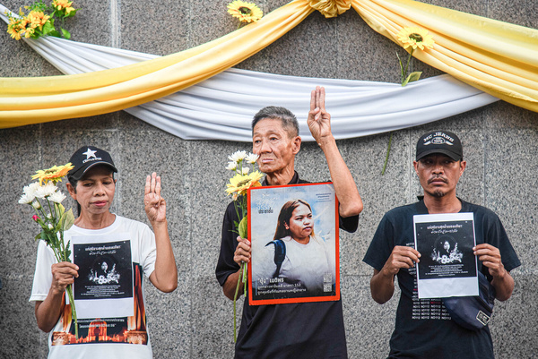 Pro-democracy activists make three finger salute and hold portraits of Netiporn Sanesangkhom during mourning ceremony outside The Southern Bangkok Criminal Court. Thai political activist Netiporn Sanesangkhom also know as "Bung Thaluwang", a 28-years-old pro-democracy activist who was charged with Lese Majeste law has passed away by cardiac arrest at Thammasart University Hospital on May 14, 2024 after hunger strike in prison since January 27,2024.