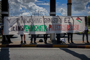 Protesters hold a banner expressing their opinion during the demonstration. Thousands of people participated in a demonstration through the streets of Pamplona calling for a free Palestine.