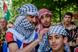 Protesters with keffiyeh scarfs prepare during the demonstration. Thousands of people participated in a demonstration through the streets of Pamplona calling for a free Palestine.