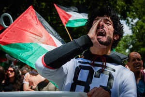 A protester chants slogans while holding a banner during the demonstration. Thousands of people participated in a demonstration through the streets of Pamplona calling for a free Palestine.