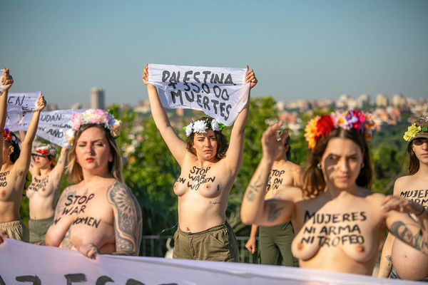 Topless Femen and Extinction Rebellion activists with slogans painted on their bodies make gestures during an action Activists from Femen Spain and Extinction Rebellion as well as other ecofeminist women have demonstrated at the Mirador del Templo de Debod in Madrid on the occasion of the International Women's Day for Peace and Disarmament.
