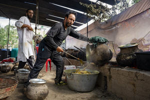 Traditional Kashmiri chefs prepare traditional Kashmiri wazwan in Srinagar. Wazwan (Kashmiri: وازِوان) is a traditional multi-course meal in Kashmiri cuisine, renowned as an art form and a cultural emblem. Predominantly meat-based, it features lamb and chicken, with a few vegetarian dishes. It is prepared by master chefs called vaste waze, and the meal is typically served during weddings and reunions. Guests share the meal from a large copper platter (traem), they begin with rice and various meat types, including seekh kababs, methi korma, tabak maaz, safed kokur, and zafran kokur. Essential dishes include rista, rogan josh, daniwal korma, aab gosh, marchhwangan korma, and gushtaba, and they conclude with desserts. And its popularity has extended internationally to food festivals and cultural events.