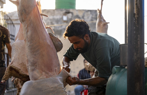 A Kashmiri butcher prepares a freshly slaughtered sheep for the traditional wazwan dishes in Srinagar. Wazwan (Kashmiri: وازِوان) is a traditional multi-course meal in Kashmiri cuisine, renowned as an art form and a cultural emblem. Predominantly meat-based, it features lamb and chicken, with a few vegetarian dishes. It is prepared by master chefs called vaste waze, and the meal is typically served during weddings and reunions. Guests share the meal from a large copper platter (traem), they begin with rice and various meat types, including seekh kababs, methi korma, tabak maaz, safed kokur, and zafran kokur. Essential dishes include rista, rogan josh, daniwal korma, aab gosh, marchhwangan korma, and gushtaba, and they conclude with desserts. And its popularity has extended internationally to food festivals and cultural events.