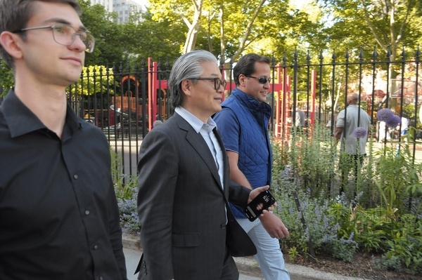 Bill Hwang, (center) founder of the hedge fund, Archegos Capital Management, walks down the street after leaving Manhattan Federal Court. Hwang attended a criminal trial at Manhattan Federal Court. Hwang has been accused of fraud after Archegos collapsed in 2021. The failure of the hedge fund caused billions of dollars in losses for banks and brokerages.