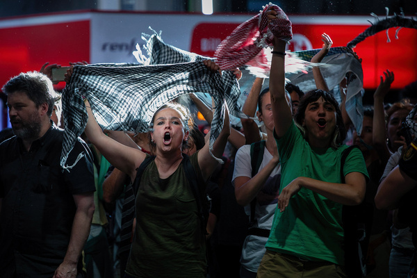 A couple of protesters chant slogans during a demonstration. Pro-Palestinian activists organized a sit-in protest at the Atocha railway station in Madrid.