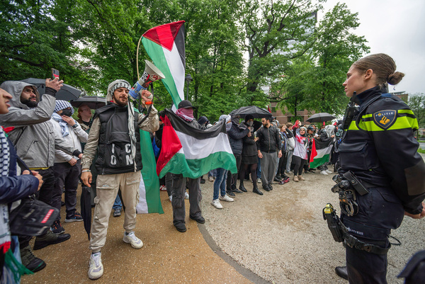 Pro-Palestinian demonstrators stand in front of police buffer line, during the 'Hands off Rafah' demonstration in The Hague. A few hundred pro-Palestinian protesters gathered in front of the 'Tweede Kamer', the Dutch seat of government in The Hague, during the 'Hands off Rafah - Where is your red line Rutte?' rally. Despite the pouring rain, demonstrators used megaphones to demand a change in the Dutch government's support for Israel. The protest was in response to a recent strike in Rafah that killed 45 people and critically injured scores, according to the Hamas-run health ministry.