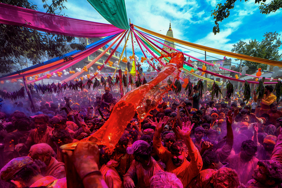 Hindu devotees are seen playing with Colorful water and powder during the Holi Festival celebration at Gokul Dham. Chaddimar Holi is a unique Holi celebration in Gokul, near Mathura, India, rooted in the legends of Lord Krishna. Women playfully strike men with small sticks called 