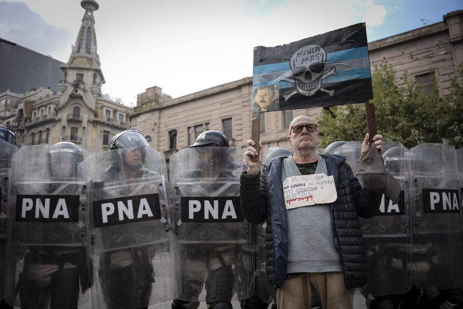 A pensioner seen with a banner in front of the police line. Javier Milei's federal police and Jorge Macri's city police repress the protest of retirees in front of the National Congress with hundreds of fans from different Argentine soccer clubs who came to support them.
