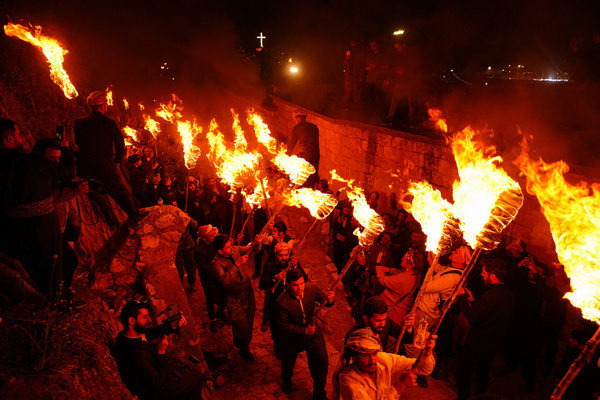 Iraqi Kurds carry fire torches as they celebrate Nowruz Day, a festival marking the first day of spring, Kurdish and Persian New Year, in the town of Akre in the Kurdistan region. Nowruz, also known as the Kurdish and Persian New Year, is a centuries-old celebration marking the arrival of spring and the start of the New Year in the Persian calendar. Observed by millions across the Middle East, Central Asia, and beyond, it symbolizes renewal, hope, and the triumph of light over darkness. The festival includes traditions such as family gatherings, festive meals, and the preparation of a "Haft-Seen" table—an arrangement of seven symbolic items starting with the Persian letter "S." Torches play a significant role in the celebration, as people carry and light them on March 20th each year to welcome Nowruz. Additionally, tailoring and clothing hold special meaning during this time—many people buy fabrics and sew traditional Kurdish costumes as part of the ritual to honor the holiday. Recognized as a UNESCO Intangible Cultural Heritage, Nowruz is celebrated by various ethnic groups, including Kurds, Persians, Afghans, and others.