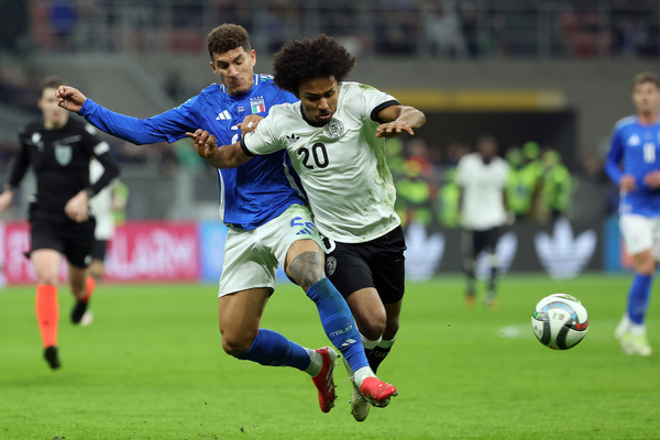 Giovanni Di Lorenzo of Italy and Karim Adeyemi of Germany seen in action during the Uefa Nations League 2025, quarter finals, football match between Italy vs Germany at Giuseppe Meazza stadium. Final score; Italy 1: 2 Germany.