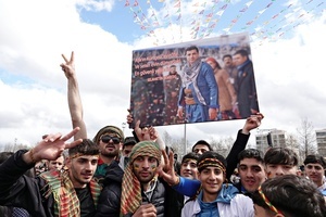 Demonstrators hold a poster of Selahattin Demirtas, the leader of the Peoples' Democracy Party (HDP), who has been held in prison for 9 years, during the Newruz celebration. Tens of thousands gather at the Newroz Square in Diyarbakir, the largest Kurdish-majority city during the final celebration of the Newroz holiday. The massive crowd celebrated with great enthusiasm, marking the occasion with vibrant festivities. This celebration is observed by the Kurdish people in Turkey across 89 locations this year.