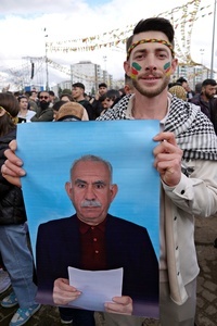 A demonstrator holds a poster of Abdullah Ocalan, the leader of the Kurdish armed organization Kurdistan Workers' Party (PKK), at the Newruz celebration. Tens of thousands gather at the Newroz Square in Diyarbakir, the largest Kurdish-majority city during the final celebration of the Newroz holiday. The massive crowd celebrated with great enthusiasm, marking the occasion with vibrant festivities. This celebration is observed by the Kurdish people in Turkey across 89 locations this year.