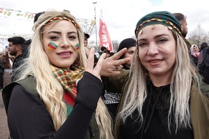 Two Kurdish women are seen making victory signs during the Newruz celebration. Tens of thousands gather at the Newroz Square in Diyarbakir, the largest Kurdish-majority city during the final celebration of the Newroz holiday. The massive crowd celebrated with great enthusiasm, marking the occasion with vibrant festivities. This celebration is observed by the Kurdish people in Turkey across 89 locations this year.