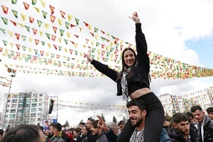 A young Kurdish woman is seen making a victory sign during the Newruz celebration. Tens of thousands gather at the Newroz Square in Diyarbakir, the largest Kurdish-majority city during the final celebration of the Newroz holiday. The massive crowd celebrated with great enthusiasm, marking the occasion with vibrant festivities. This celebration is observed by the Kurdish people in Turkey across 89 locations this year.