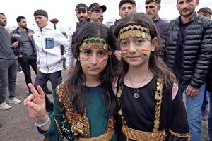 Two girls are seen participating in the Newruz celebration. Tens of thousands gather at the Newroz Square in Diyarbakir, the largest Kurdish-majority city during the final celebration of the Newroz holiday. The massive crowd celebrated with great enthusiasm, marking the occasion with vibrant festivities. This celebration is observed by the Kurdish people in Turkey across 89 locations this year.