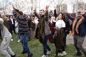 People are seen dancing and making victory signs at the Newruz celebration. Tens of thousands gather at the Newroz Square in Diyarbakir, the largest Kurdish-majority city during the final celebration of the Newroz holiday. The massive crowd celebrated with great enthusiasm, marking the occasion with vibrant festivities. This celebration is observed by the Kurdish people in Turkey across 89 locations this year.