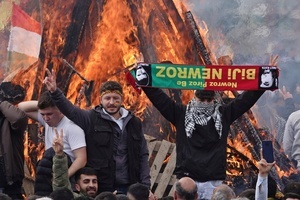 Young people are seen making victory signs in front of a fire lit during the Newruz celebration. Tens of thousands gather at the Newroz Square in Diyarbakir, the largest Kurdish-majority city during the final celebration of the Newroz holiday. The massive crowd celebrated with great enthusiasm, marking the occasion with vibrant festivities. This celebration is observed by the Kurdish people in Turkey across 89 locations this year.