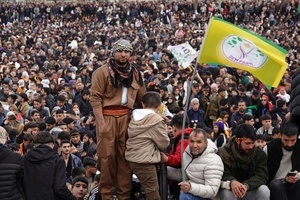 A demonstrator waves the flag of the Peoples' Equality and Democracy Party (DEM Party) during the Newruz celebration. Tens of thousands gather at the Newroz Square in Diyarbakir, the largest Kurdish-majority city during the final celebration of the Newroz holiday. The massive crowd celebrated with great enthusiasm, marking the occasion with vibrant festivities. This celebration is observed by the Kurdish people in Turkey across 89 locations this year.
