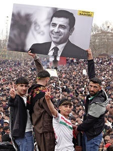 Demonstrators holding a poster of Selahattin Demirtas, the leader of the Peoples' Democracy Party (HDP), who has been held in prison for 9 years, are seen during the Newruz celebration. Tens of thousands gather at the Newroz Square in Diyarbakir, the largest Kurdish-majority city during the final celebration of the Newroz holiday. The massive crowd celebrated with great enthusiasm, marking the occasion with vibrant festivities. This celebration is observed by the Kurdish people in Turkey across 89 locations this year.