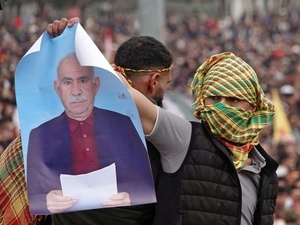 A demonstrator holds a poster of Abdullah Ocalan, the leader of the Kurdish armed organization Kurdistan Workers' Party (PKK), during the Newruz celebration. Tens of thousands gather at the Newroz Square in Diyarbakir, the largest Kurdish-majority city during the final celebration of the Newroz holiday. The massive crowd celebrated with great enthusiasm, marking the occasion with vibrant festivities. This celebration is observed by the Kurdish people in Turkey across 89 locations this year.