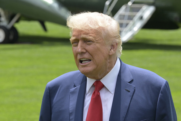 President Trump speaks to reporters (not in view) about CA Governor Gavin Newsom upon his arrival at the White House in Washington.