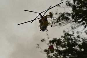 A firefighting helicopter flies near the site of a Russian drone strike amidst Russia's attack. Russia carried out "massive" drone attacks on Ukraine's capital and port city of Odesa killing one person and hitting a maternity hospital, Ukrainian officials said calling for further sanctions.