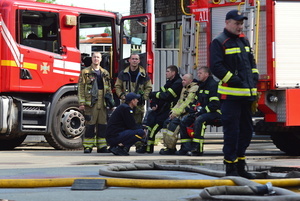 Firefighters rest after extinguishing a fire at the site of a Russian drone strike amidst Russia's attack. Russia carried out "massive" drone attacks on Ukraine's capital and port city of Odesa killing one person and hitting a maternity hospital, Ukrainian officials said, and called for further sanctions.
