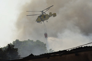 A firefighting helicopter flies near the site of a Russian drone strike amidst Russia's attack. Russia carried out "massive" drone attacks on Ukraine's capital and port city of Odesa killing one person and hitting a maternity hospital, Ukrainian officials said, and called for further sanctions.