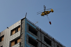 A firefighting helicopter flies near the site of a Russian drone strike amidst Russia's attack. Russia carried out "massive" drone attacks on Ukraine's capital and port city of Odesa killing one person and hitting a maternity hospital, Ukrainian officials said calling for further sanctions.
