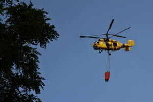 A firefighting helicopter flies near the site of a Russian drone strike amidst Russia's attack. Russia carried out "massive" drone attacks on Ukraine's capital and port city of Odesa killing one person and hitting a maternity hospital, Ukrainian officials said, and called for further sanctions.