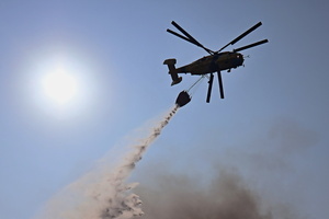 A firefighting helicopter flies near the site of a Russian drone strike amidst Russia's attack. Russia carried out "massive" drone attacks on Ukraine's capital and port city of Odesa killing one person and hitting a maternity hospital, Ukrainian officials said, and called for further sanctions.