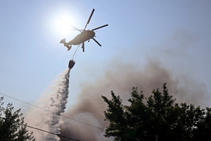 A firefighting helicopter flies near the site of a Russian drone strike amidst Russia's attack. Russia carried out "massive" drone attacks on Ukraine's capital and port city of Odesa killing one person and hitting a maternity hospital, Ukrainian officials said calling for further sanctions.