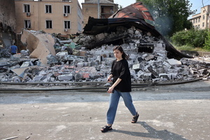 A girl walks past a destroyed building hit by a Russian drone amidst Russia's attack. Russia carried out "massive" drone attacks on Ukraine's capital and port city of Odesa killing one person and hitting a maternity hospital, Ukrainian officials said, and called for further sanctions.