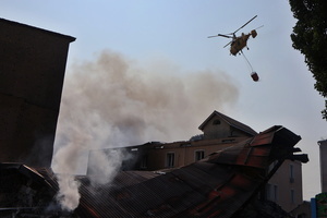 A firefighting helicopter flies near the site of a Russian drone strike amidst Russia's attack. Russia carried out "massive" drone attacks on Ukraine's capital and port city of Odesa killing one person and hitting a maternity hospital, Ukrainian officials said, and called for further sanctions.