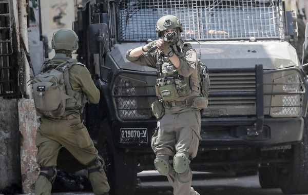 An Israeli soldier takes position during an Israeli military operation inside the Balata refugee camp in the West Bank city of Nablus. The Israeli army launched a large-scale arrest campaign, raiding and ransacking Palestinian homes. During the operation, several Palestinians were detained, and residents were forced to evacuate. Notably, many of these evacuated Palestinian homes were seized and converted by Israeli forces into military barracks.
