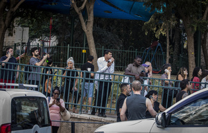 Israelis talk on their cellphones after an Iranian ballistic missile strike. An Iranian missile struck the main hospital in southern Israel early Thursday, causing extensive damage and wounding several people, though none seriously, according to the hospital. Other missiles hit a high-rise apartment building in Ramat Gan, and additional sites in central Israel, leaving at least 240 wounded and four of them seriously according to Israel's Health Ministry.