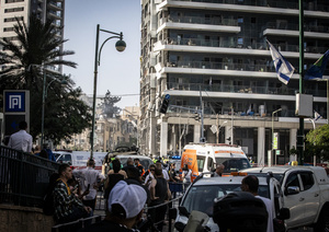 Israeli first responders seen near a building after an Iranian ballistic missile strike. An Iranian missile struck the main hospital in southern Israel early Thursday, causing extensive damage and wounding several people, though none seriously, according to the hospital. Other missiles hit a high-rise apartment building in Ramat Gan, and additional sites in central Israel, leaving at least 240 wounded and four of them seriously according to Israel's Health Ministry.
