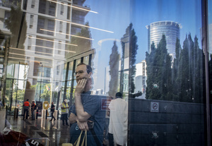 A man looks on as he stands in a building that was affected by an Iranian ballistic missile strike. An Iranian missile struck the main hospital in southern Israel early Thursday, causing extensive damage and wounding several people, though none seriously, according to the hospital. Other missiles hit a high-rise apartment building in Ramat Gan, and additional sites in central Israel, leaving at least 240 wounded and four of them seriously according to Israel's Health Ministry.