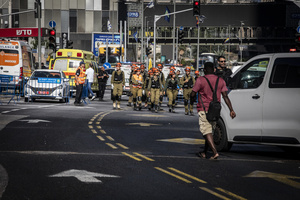 Israeli first responders arrive at a site after an Iranian ballistic missile strike. An Iranian missile struck the main hospital in southern Israel early Thursday, causing extensive damage and wounding several people, though none seriously, according to the hospital. Other missiles hit a high-rise apartment building in Ramat Gan, and additional sites in central Israel, leaving at least 240 wounded and four of them seriously according to Israel's Health Ministry.