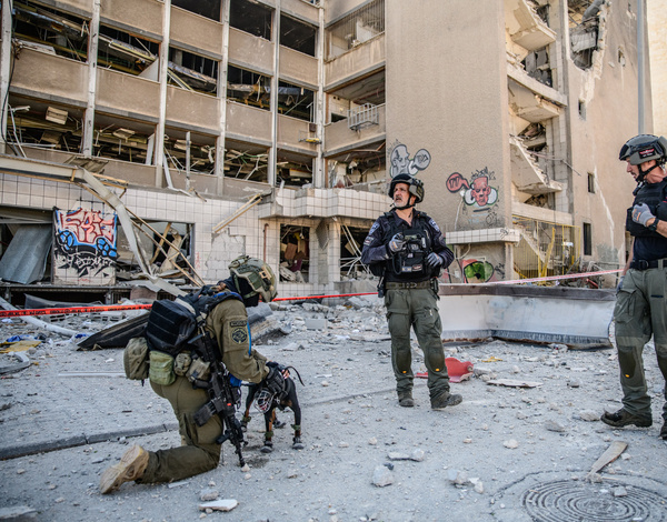 Israeli police and rescue forces inspect the site of an Iranian ballistic missile direct hit site in Haifa .