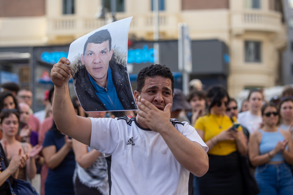 Abderrahim's brother, Mourad, shouts while holding a sign and a photo of his brother's face. during a demonstration in Callao Square in central Madrid, to condemn the murder of Abderrahim. On Tuesday, June 17, an off-duty police officer strangled Abderrahim, a Moroccan, in Torrejón de Ardoz, Madrid, after the latter was accused of stealing his cell phone.