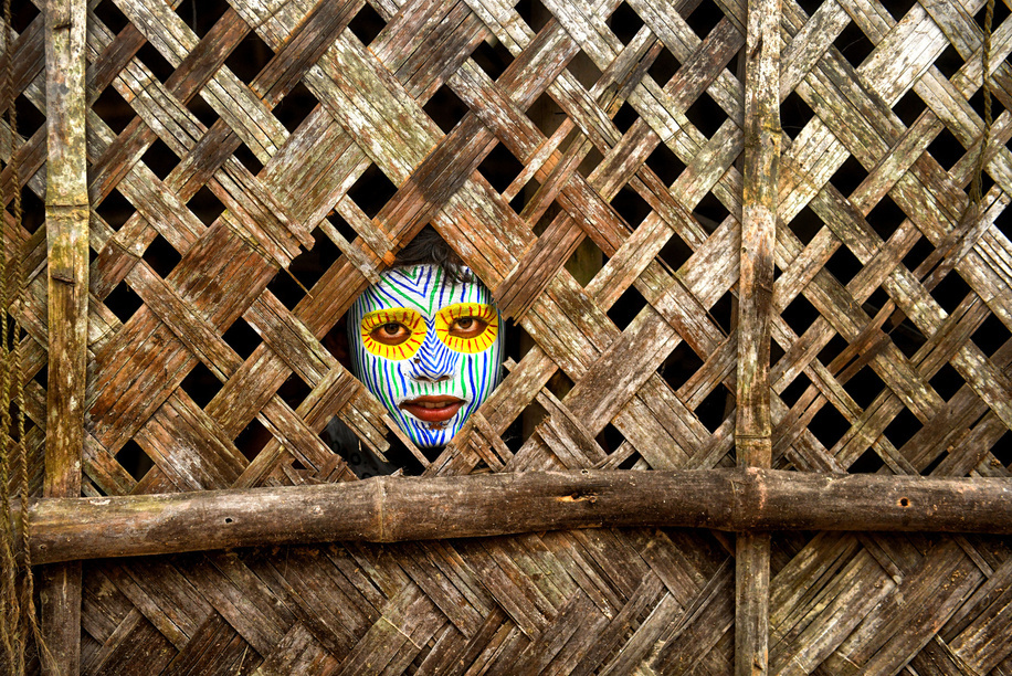 A child poses with face painting during the event. For generations Bahurupi artists from West Bengal have been practicing in the art of face painting. Using their painting techniques they can easily metamorphose into different characters during a performance, which often represents tribal myths. These traditional artists scrape a living from their performances, relying on the generosity of audiences for their income.