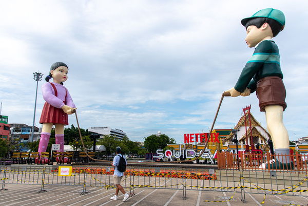 A 12 meter-tall statue of Young-hee (L), the iconic doll and a 12 meter-tall statue of a newly revealed character Cheol-su (R) from Netflix's South Korean series "Squid Game", seen displayed for promotional event of the Netflix's series " Squid Game season 3 " at Lan Khon Mueang. The Netflix's series " Squid Game season 3 " will be released on June 27,2025.